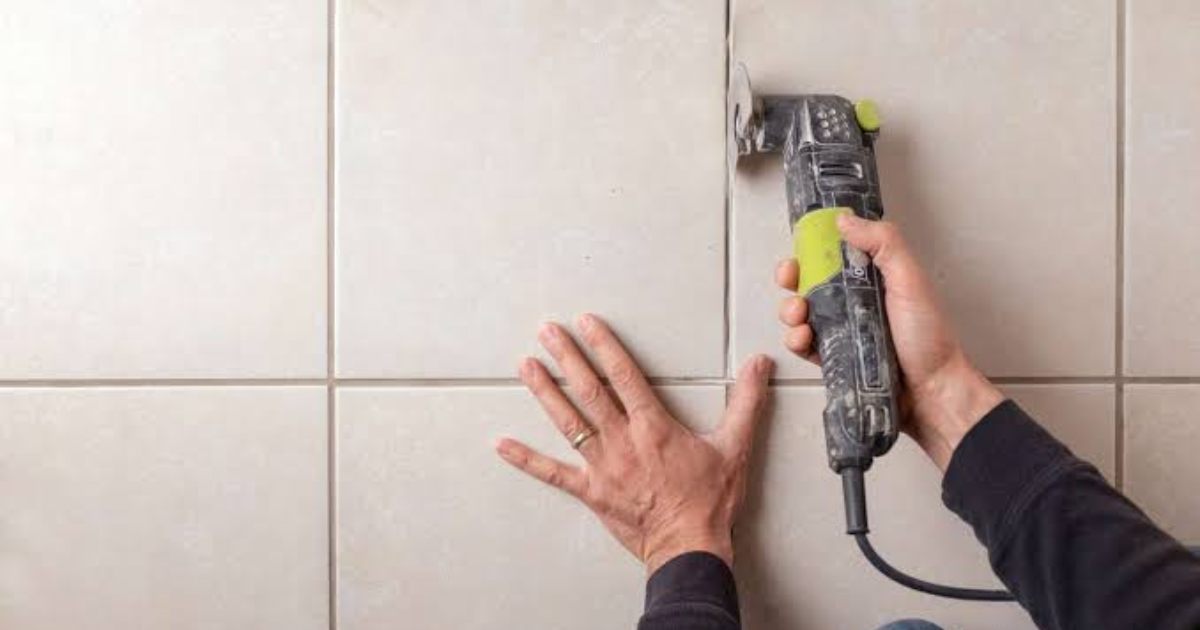 Tile regrouting in a bathroom shower with clean restored grout